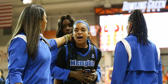 Memphis Tigers guard Jamirah Shutes, center, is escorted off the court after an altercation with Bowling Green Falcons guard Elissa Brett during the postgame handshake following a third-round game in the Women's National Invitational Tournament at the Stroh Center in Bowling Green, Ohio, on Thursday.