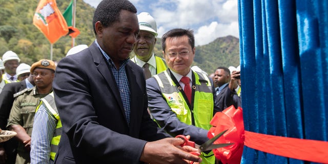 Zambian President Hakainde Hichilema cuts the ribbon when attending the commissioning ceremony for the fifth generator at the Kafue Gorge Lower Hydropower Station in Southern Province, Zambia, on March 24, 2023.