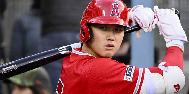 Shohei Ohtani de los Angelinos calienta durante un partido de exhibición contra los Dodgers en el Dodger Stadium de Los Ángeles el domingo 26 de marzo de 2023.