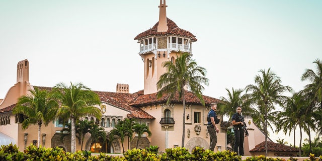 Secret Service agents stand guard outside the Mar-a-Lago home of former President Donald Trump on March 27, 2023, in Palm Beach, Florida.