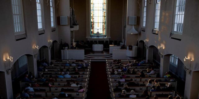 People attend a vigil at Woodmont Christian for those who were killed in a mass shooting at The Covenant School on March 27, 2023, in Nashville, Tennessee.