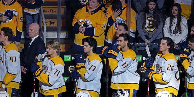 Predators players take off their helmets for a moment of silence, in honor of the Nashville school shooting victims.