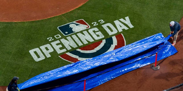 The tarp is removed to reveal the Opening Day logo prior to the 2023 Opening Day game between the Boston Red Sox and Baltimore Orioles on March 30, 2023 at Fenway Park in Boston.