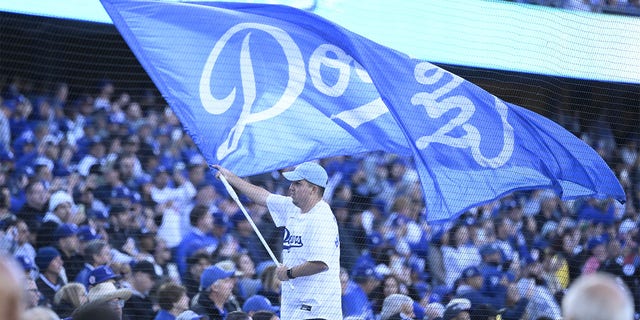 A Dodgers flag is flown on Opening Day