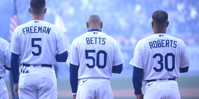 From left to right, Freddie Freeman, Mookie Betts and Dave Roberts prior to an Opening Day baseball game between the Los Angeles Dodgers and the Arizona Diamondbacks at Dodger Stadium in Los Angeles on Thursday, March 30, 2023.