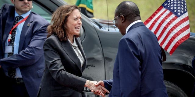 Vice President Kamala Harris shakes hand with Tanzania's Vice President, Dr. Philip Mpango, upon her arrival at the Julius Nyerere International Airport in Dar es Salaam to depart to Lusaka, Zambia, at the end of her visit to Tanzania on Friday.