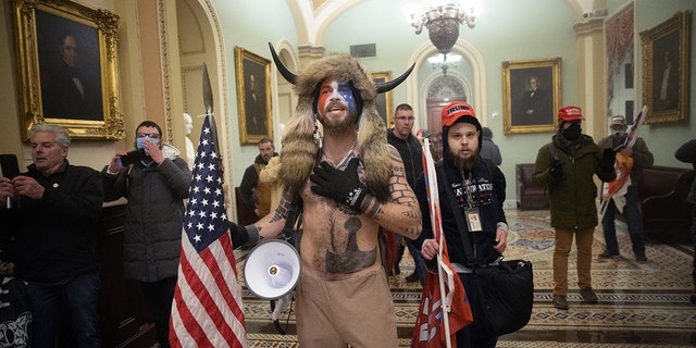A pro-Trump mob confronts US Capitol police outside the Senate chamber of the US Capitol Building on January 06, 2021, in Washington, DC. 