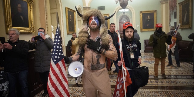 A pro-Trump mob confronts US Capitol police outside the Senate chamber of the US Capitol Building on January 06, 2021, in Washington, DC.