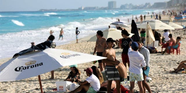 Bathers enjoy the public beach as tourists return to the city during Holy Week on April 3, 2021, in Cancun, Mexico.