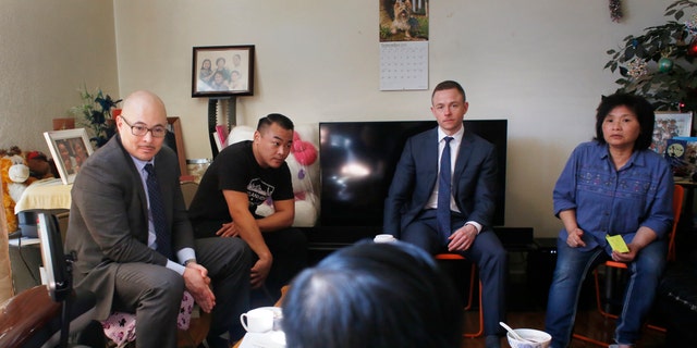 John Hamasaki (back left), attorney for Lam family, meets in the Lam family home during an interview on Sunday, March 12, 2017, in Oakland, Calif. 