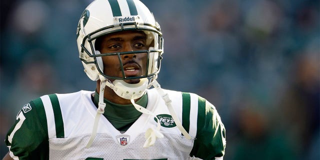 The New York Jets' Plaxico brace warms up before the start of a game against the Philadelphia Eagles at Lincoln Financial Field, Dec. 18, 2011, in Philadelphia.