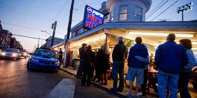 Customers wait in line at Pat's King of Steaks in Philadelphia, Pennsylvania, on Jan. 7, 2012. 聽A man and a woman pled guilty in connection with a fatal shooting outside the famous cheesesteak shop in 2021.