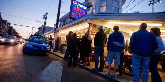 Customers wait in line at Pat's King of Steaks in Philadelphia, Pennsylvania, on Jan. 7, 2012. A man and a woman pled guilty in connection with a fatal shooting outside the famous cheesesteak shop in 2021.