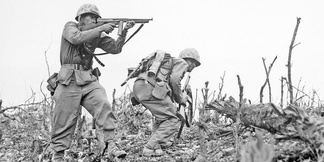 A U.S. Marine from the 2nd Battalion, 1st Marines on Wana Ridge, firing a Thompson submachine gun. Battle of Okinawa, May 1945. 