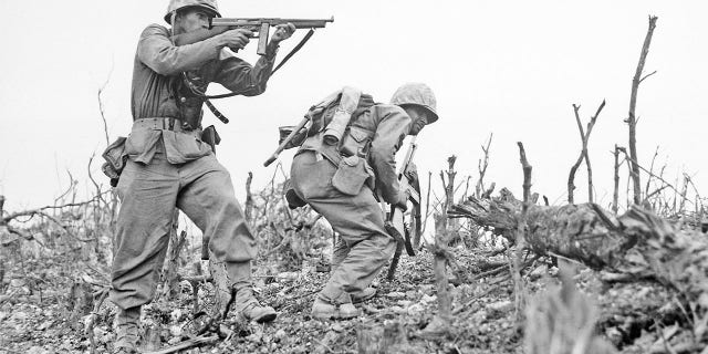 A U.S. Marine from the 2nd Battalion, 1st Marines on Wana Ridge, firing a Thompson submachine gun. Battle of Okinawa, May 1945.