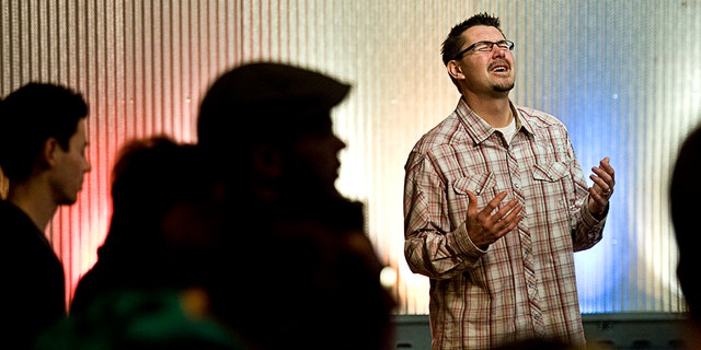 Pastor Mark Batterson leads a prayer at the conclusion of a 21-day prayer vigil at Ebenzers Coffeehouse on January 2012 in Washington, D.C. 