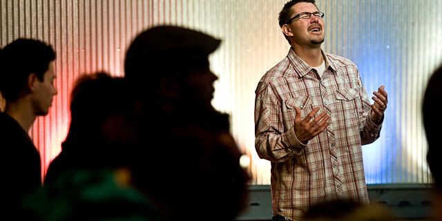 Pastor Mark Batterson leads a prayer at the conclusion of a 21-day prayer vigil at Ebenzers Coffeehouse on January 2012 in Washington, D.C.