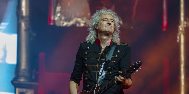 Bryan May, the guitarist for Queen, performs during "The Rhapsody Tour."