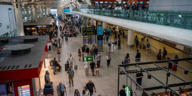 Travelers in the arrival hall of Humberto Delgado International Airport Terminal 1, Aug. 27, 2022, in Lisbon, Portugal. 