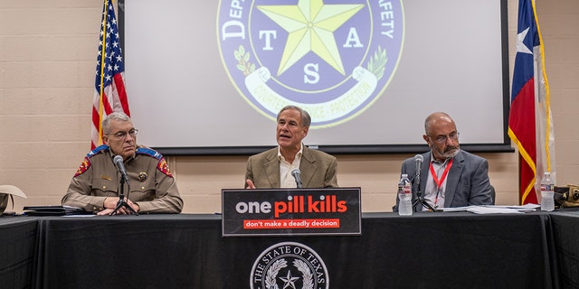 Texas Gov. Greg Abbott, center, speaks at a news conference on October 17, 2022, in Beaumont, Texas. 