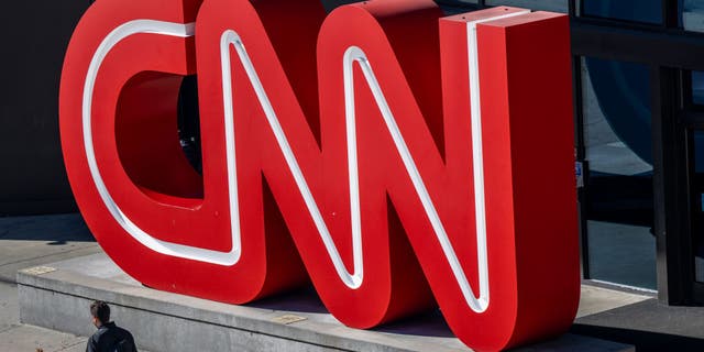 A person walks past the headquarters of the Cable News Network (CNN) on November 17, 2022, in Atlanta, Georgia.