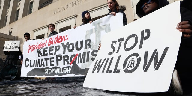 Climate activists hold a demonstration to urge President Biden to reject the Willow Project at the Department of the Interior headquarters on Nov. 17 in Washington, D.C.