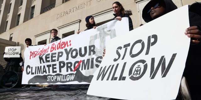 Climate activists hold a demonstration to urge President Biden to reject the Willow Project at the Department of the Interior headquarters on Nov. 17 in Washington, DC