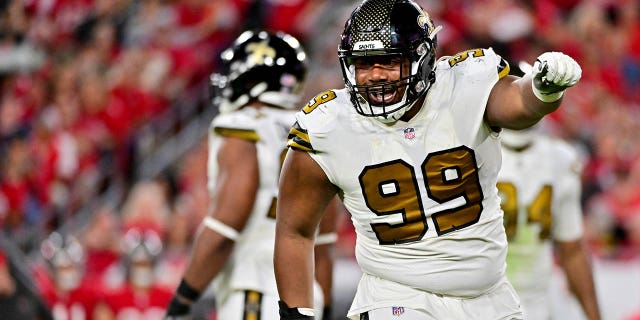 Shy Tuttle #99 of the New Orleans Saints celebrates after sacking Tom Brady #12 of the Tampa Bay Buccaneers during the fourth quarter in the game at Raymond James Stadium on December 05, 2022 in Tampa, Florida.