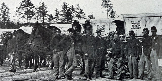 An ambulance train during the American Civil War, shown in a black and white photograph of soldiers and horses. Advances in battlefield medicine during the Civil War played a huge role in civilian emergency care after the war, including the introduction of ambulance services.