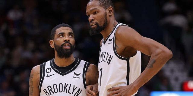 Kevin Durant (7) and Kyrie Irving (11) of the Brooklyn Nets react during a game against the New Orleans Pelicans at the Smoothie King Center Jan. 6, 2023, in New Orleans.