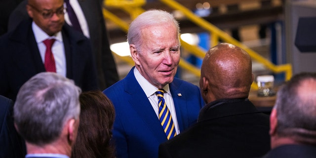 President Biden speaks with New York City Mayor Eric Adams after giving a speech on infrastructure at the West Side Yard on Jan. 31, 2023. Adams said serving on Biden's re-election panel would not compromise his migrant crisis stance. 