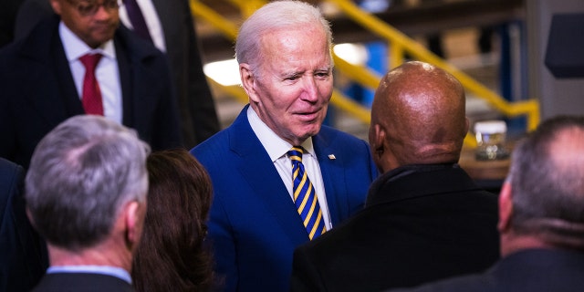 President Biden speaks with New York City Mayor Eric Adams after giving a speech on infrastructure at the West Side Yard on Jan. 31, 2023. Adams said serving on Biden's re-election panel would not compromise his migrant crisis stance. 