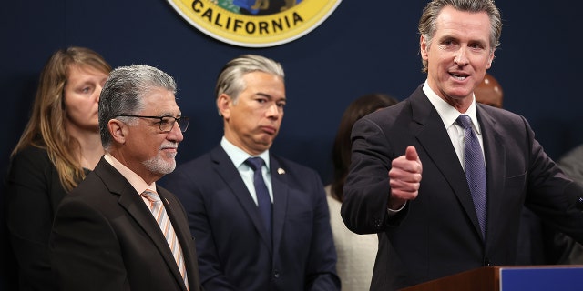 California Gov. Gavin Newsom, right, speaks as state Senator Anthony Portantino (D-Burbank), left, and California Attorney General Rob Bonta, center, look on during a press conference.