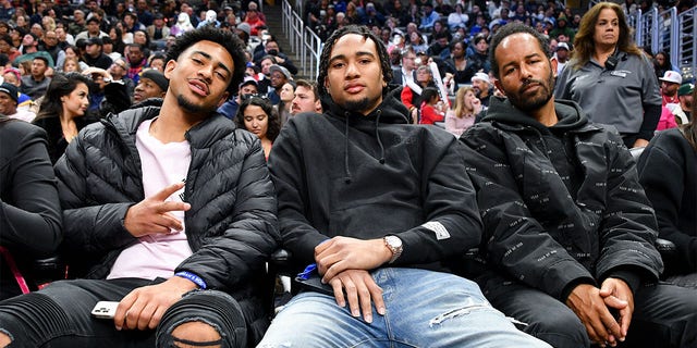 (L-R) Bryce Young, C.J. Stroud and Harold Hadnott attend a game between the Los Angeles Clippers and the Golden State Warriors at Crypto.com Arena Feb. 14, 2023, in Los Angeles. 