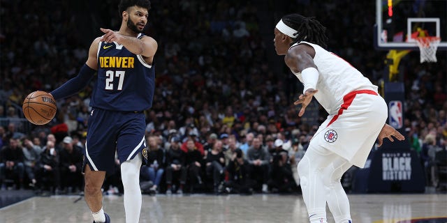 Jamal Murray (27) of the Denver Nuggets brings the ball down the court against Terance Mann (14) of the Los Angeles Clippers in the second quarter at Ball Arena Feb. 26, 2023, in Denver, Colo.