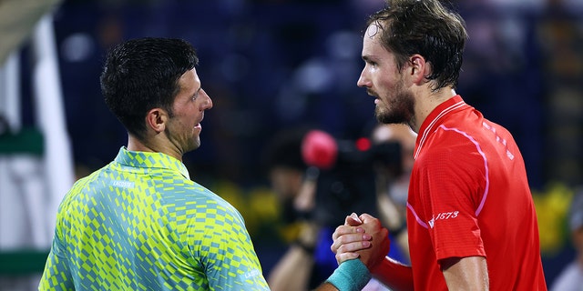 Novak Djokovic of Serbia shakes hands with Daniil Medvedev after being defeated by him during day 13 of Dubai Duty Free Tennis at Dubai Duty Free Tennis Stadium on March 3, 2023, in Dubai, United Arab Emirates.