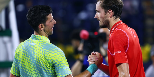 Novak Djokovic of Serbia shakes hands with Daniil Medvedev after being defeated by him during day 13 of Dubai Duty Free Tennis at Dubai Duty Free Tennis Stadium on March 3, 2023, in Dubai, United Arab Emirates.