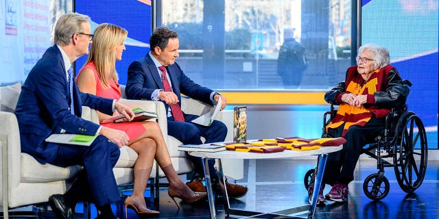 Hosts Steve Doocy, Ainsley Earhardt and Brian Kilmeade with Jean Dolores Schmidt, also known as Sister Jean, as she visits "Fox and Friends" at Fox News Studios March 7, 2023, in New York City.