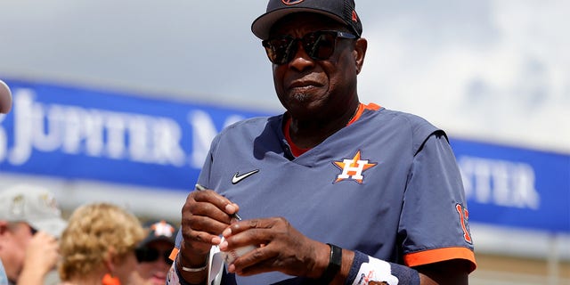 Dusty Baker Jr. of the Houston Astros signs autographs for fans prior to a game against the St. Louis Cardinals at Roger Dean Stadium March 6, 2023, in Jupiter, Fla. 
