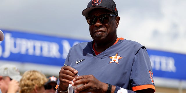 Dusty Baker Jr. of the Houston Astros signs autographs for fans prior to a game against the St. Louis Cardinals at Roger Dean Stadium March 6, 2023, in Jupiter, Fla. 