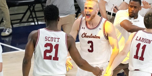 Dalton Bolon and Jaylon Scott of the Charleston Cougars celebrate during the CAA Men's Basketball Championship game against the North Carolina-Wilmington Seahawks on March 7, 2023, in Washington, D.C.