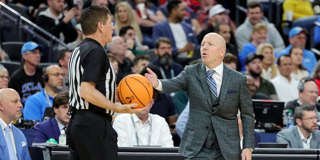 UCLA Bruins head coach Mick Cronin talks to a referee in the second half of the championship game of the Pac-12 basketball tournament against the Arizona Wildcats at T-Mobile Arena on March 11, 2023 in Las Vegas. The Wildcats defeated the Bruins 61-59.