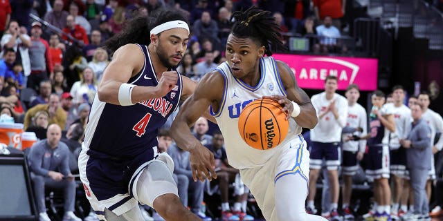 Dylan Andrews, #2 of the UCLA Bruins, drives against Kylan Boswell, #4 of the Arizona Wildcats, in the second half of the championship game of the Pac-12 basketball tournament at T-Mobile Arena on March 11, 2023 in Las Vegas. The Wildcats defeated the Bruins 61-59.