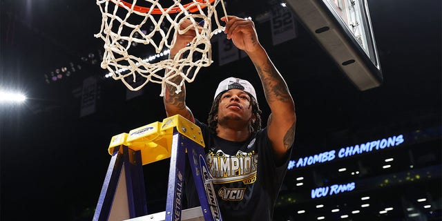Adrian Baldwin Jr. #1 of the Virginia Commonwealth Rams cuts through the net after defeating the Dayton Flyers to win the A10 Basketball Tournament Championship at Barclays Center on March 12, 2023 in New York City.  The Virginia Commonwealth Rams defeated the Dayton Flyers 68-56.