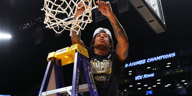 Adrian Baldwin Jr. #1 of the Virginia Commonwealth Rams cuts through the net after defeating the Dayton Flyers to win the A10 Basketball Tournament Championship at Barclays Center on March 12, 2023 in New York City.  The Virginia Commonwealth Rams defeated the Dayton Flyers 68-56.