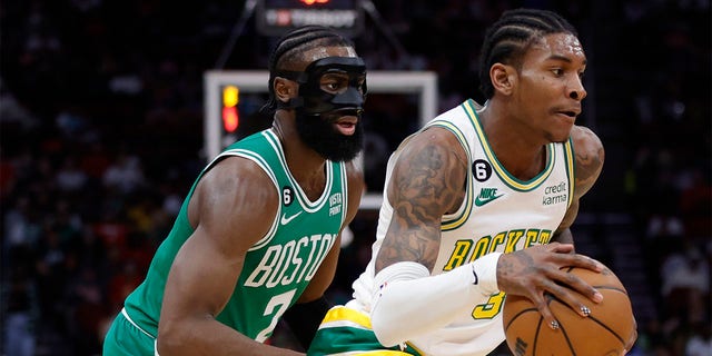 Kevin Porter Jr. #3 of the Houston Rockets drives ahead of Jaylen Brown #7 of the Boston Celtics during the first half at Toyota Center on March 13, 2023 in Houston, Texas. 