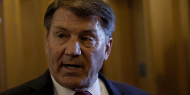 Sen.  Mike Rounds speaks to reporters outside the Senate Chambers during a vote in the US Capitol.