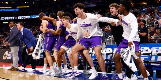 Furman players react during the Virginia game at Amway Center on March 16, 2023, in Orlando, Florida.