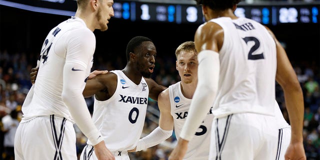 Souley Boum, second from left, huddles with Xavier teammates Jack Nunge, left, Adam Kunkel and Jerome Hunter during the first half of their first-round game against Kennesaw State in the NCAA Men's Basketball Tournament at The Fieldhouse at Greensboro Coliseum in Greensboro, N.C., on Friday.