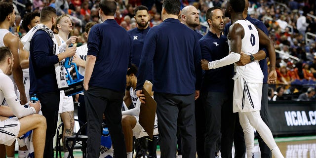 Souley Boum, right, of the Xavier Musketeers argues with teammate Adam Kunkel in their game against the Kennesaw State Owls in the first round of the NCAA Men's Basketball Tournament at The Fieldhouse at Greensboro Coliseum in Greensboro, N.C., on Friday.